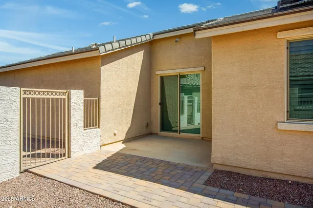 a view of a house with a swimming pool and sitting area
