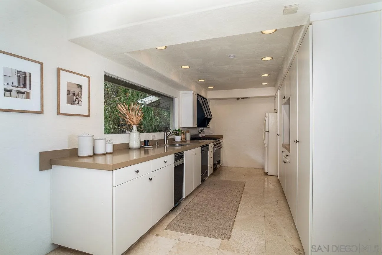 2349 Rue Adriane La Jolla, CA 92037 - Photo 12 of 36 a kitchen with a sink and cabinets