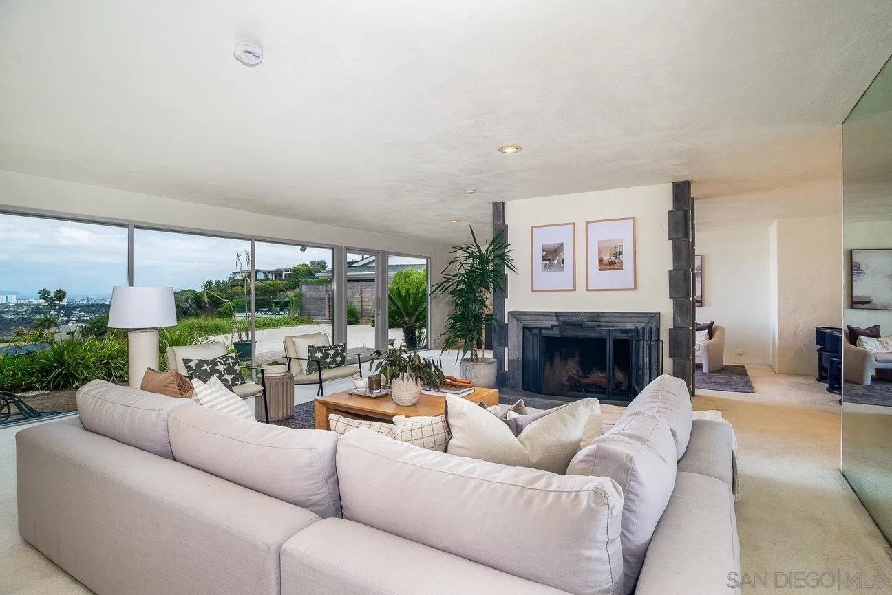 2349 Rue Adriane La Jolla, CA 92037 - Photo 15 of 36 a living room with furniture fireplace and a large window
