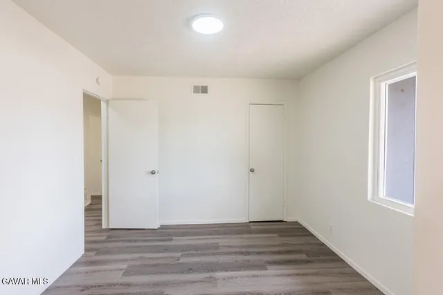 a view of an empty room and wooden floor