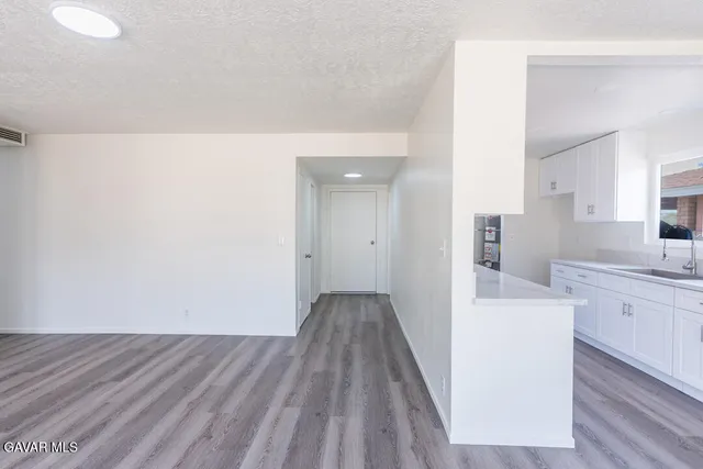a view of a kitchen from the hallway