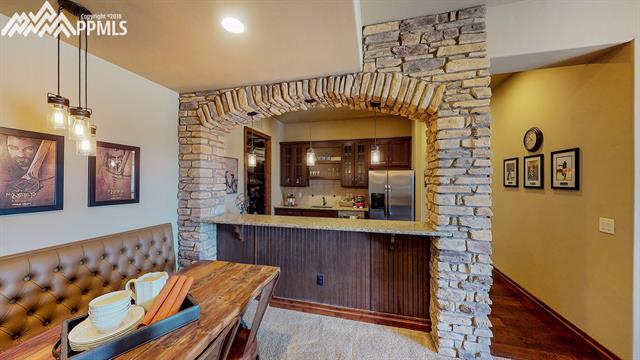 1023 Old North Gate Road Colorado Springs, CO 80921 - Photo 22 of 34 Arch over bar at Basement Kitchen/Bar - Fridge, Sink, Dishwasher