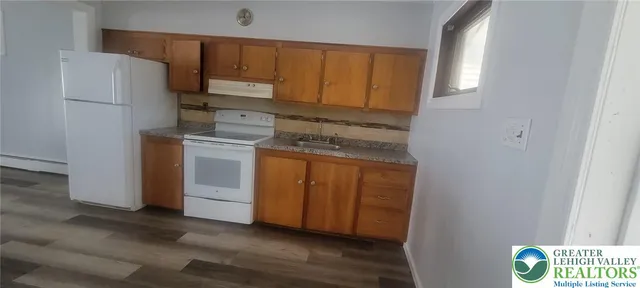 a kitchen with a refrigerator sink and stove