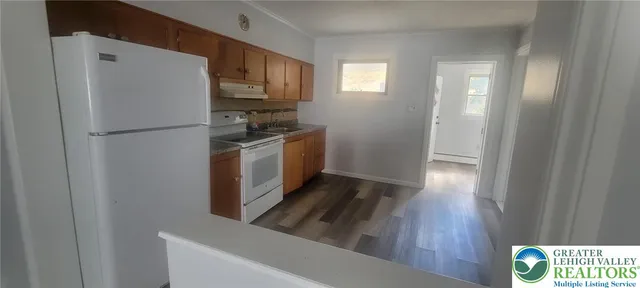 a kitchen with stainless steel appliances a refrigerator a stove a microwave and cabinets