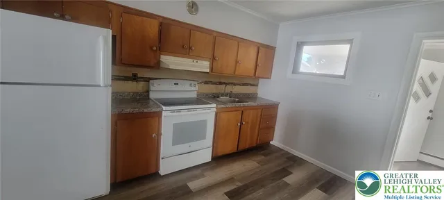 a kitchen with a sink a stove and cabinets