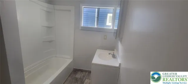 a bathroom with a bathtub and shower