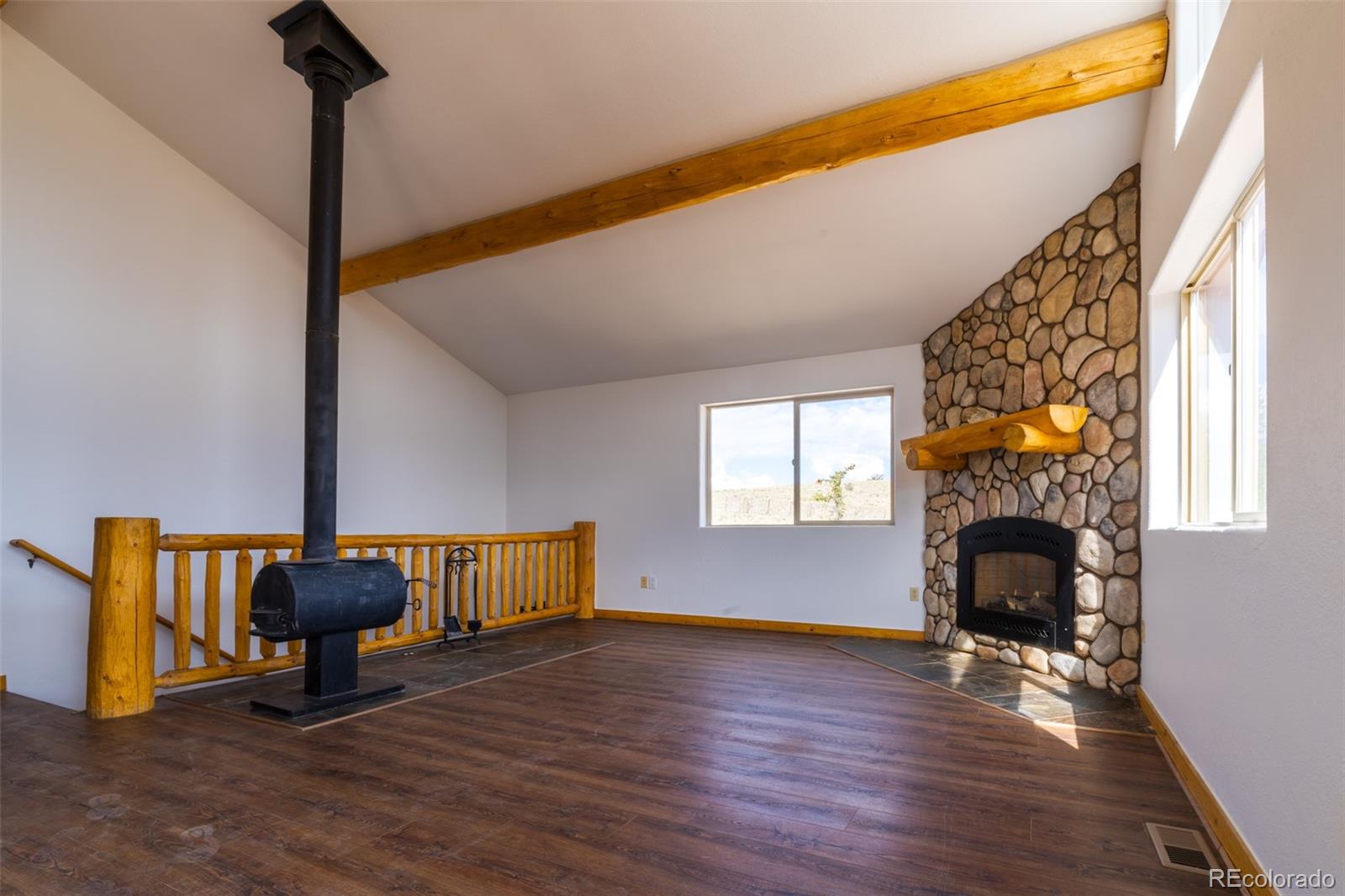 1155 Travois Road Jefferson, CO 80456 - Photo 11 of 31 a living room with furniture and a fireplace