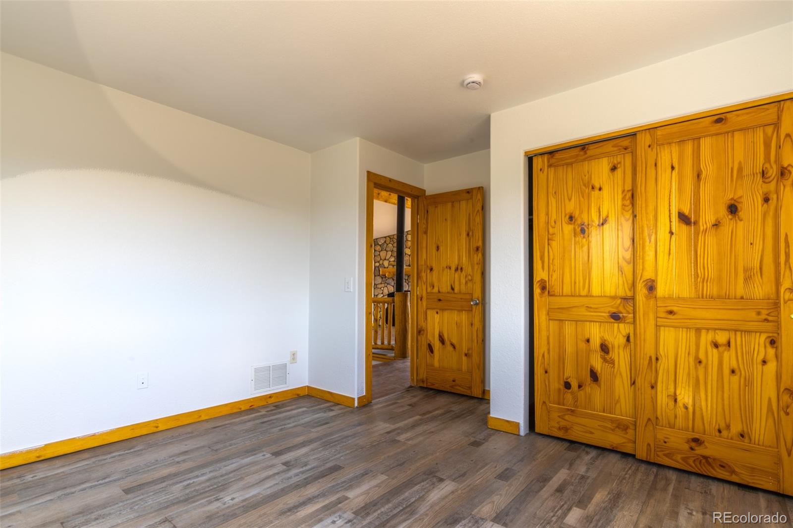 1155 Travois Road Jefferson, CO 80456 - Photo 15 of 31 a view of an empty room with wooden floor