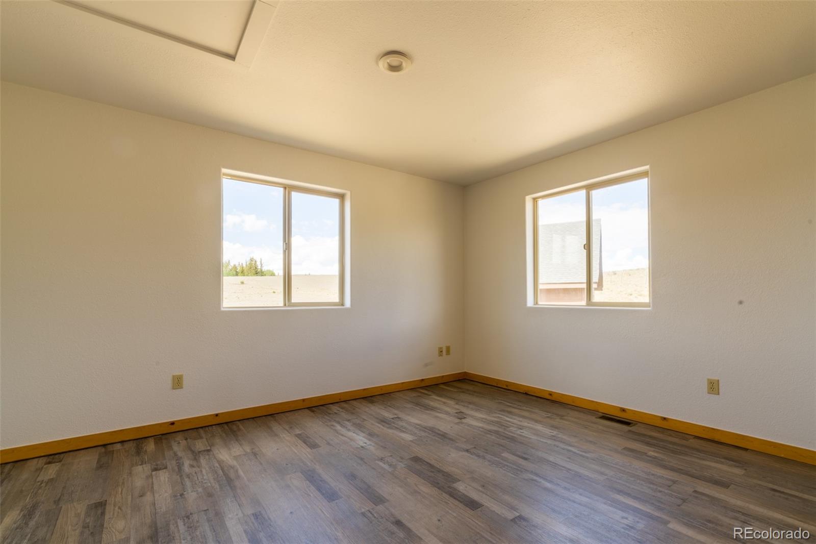 1155 Travois Road Jefferson, CO 80456 - Photo 16 of 31 a view of a room with wooden floor and windows