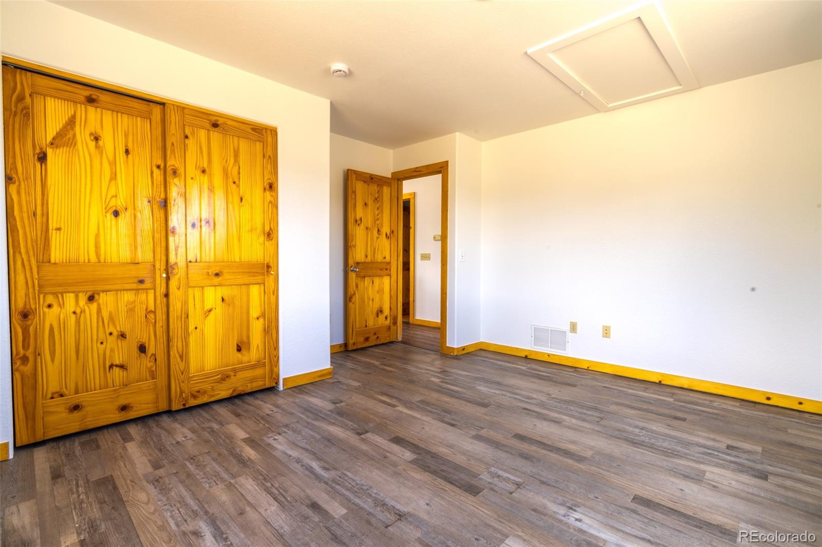 1155 Travois Road Jefferson, CO 80456 - Photo 17 of 31 a view of an empty room with wooden floor