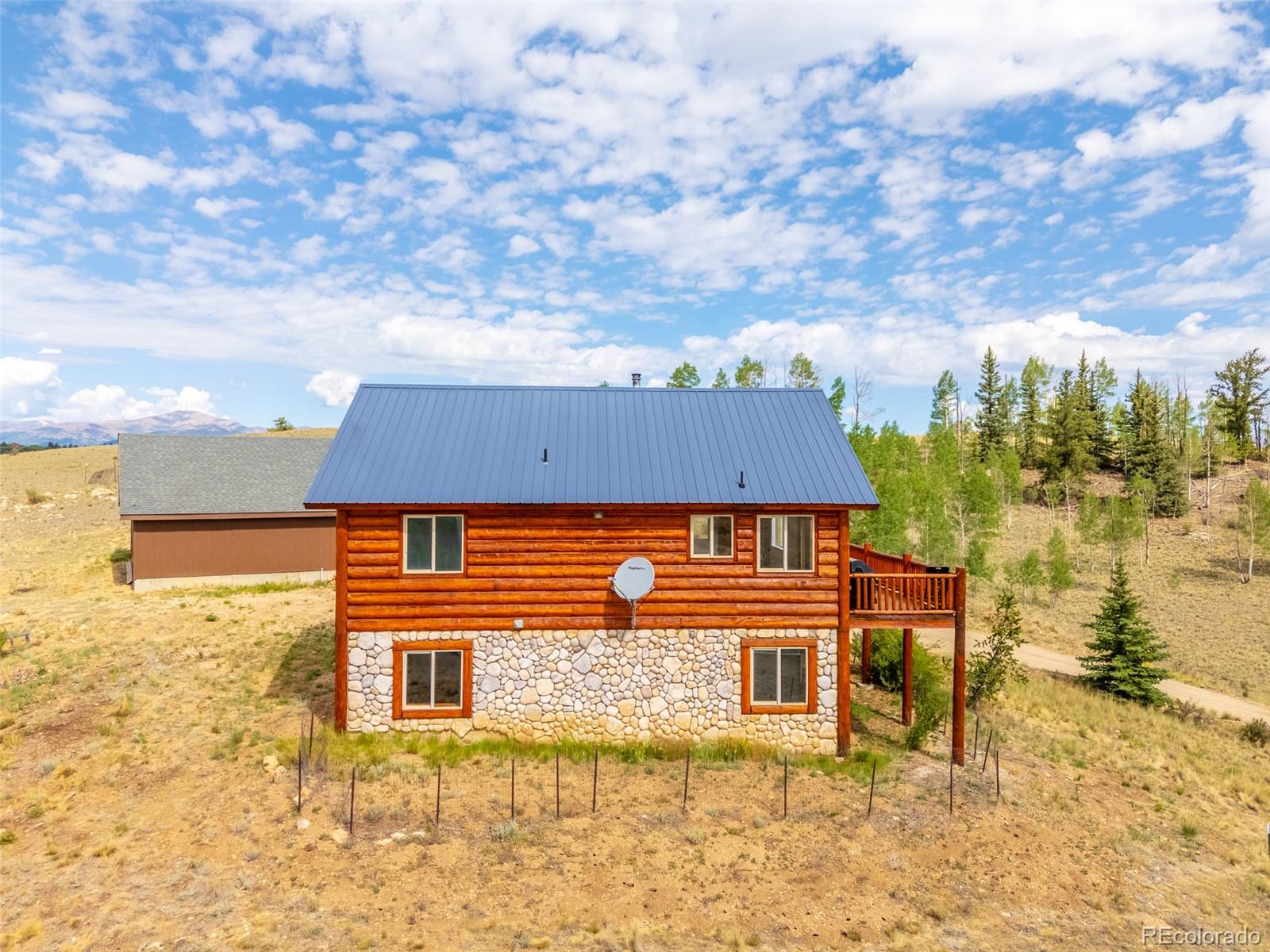 1155 Travois Road Jefferson, CO 80456 - Photo 7 of 31 front view of a house with a yard