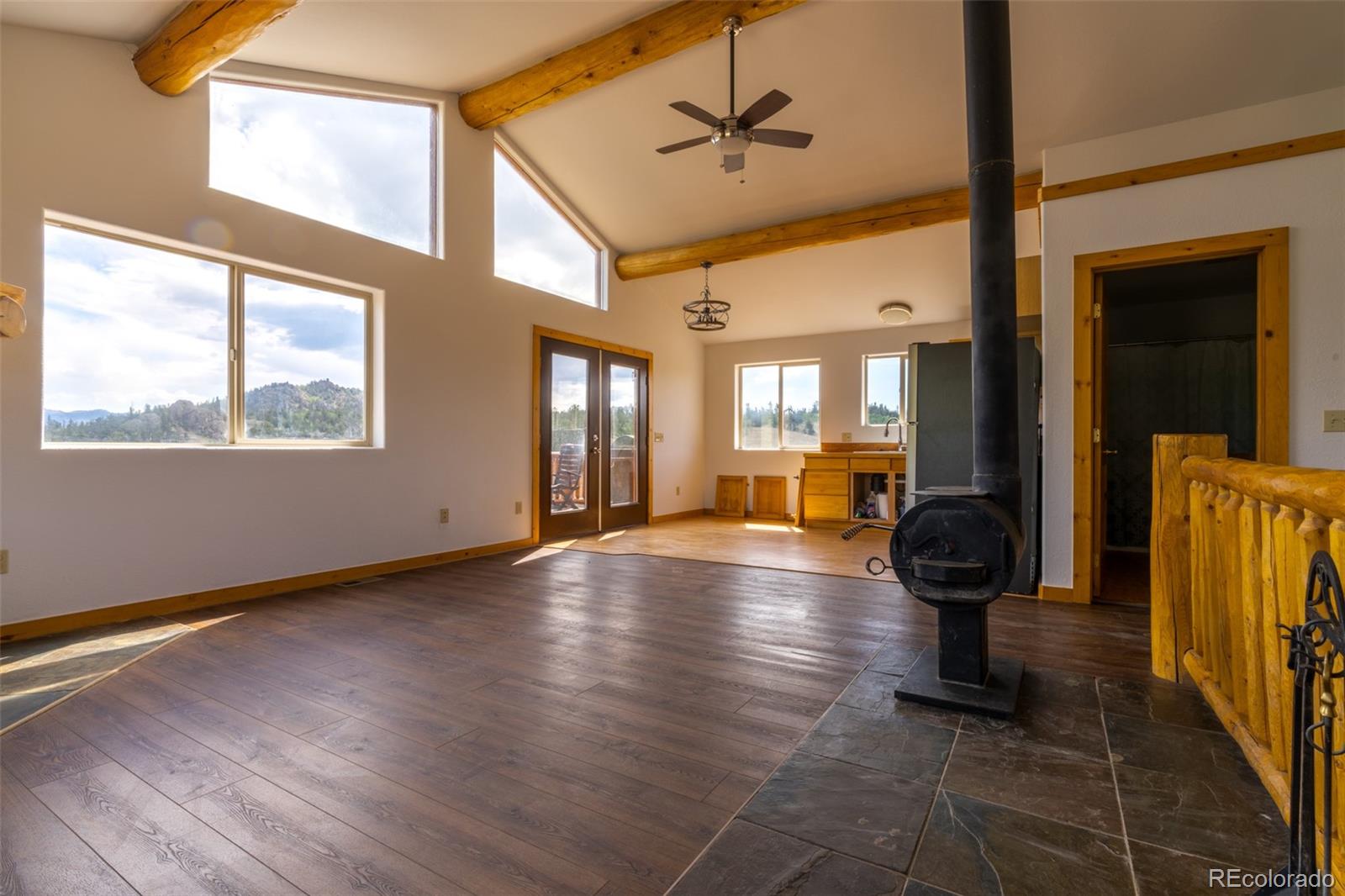 1155 Travois Road Jefferson, CO 80456 - Photo 10 of 31 a view of a livingroom with furniture hardwood floor a ceiling fan and windows