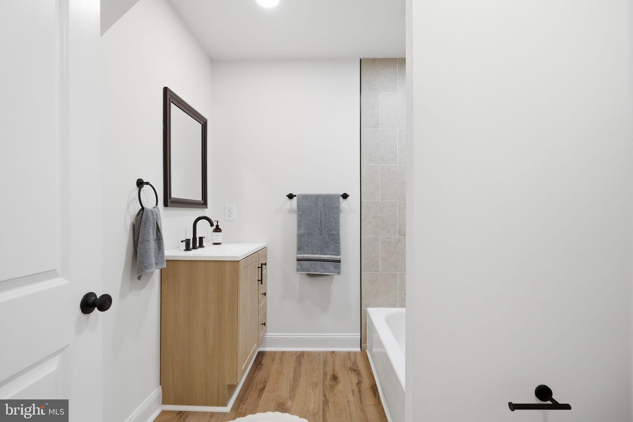 409 South Providence Road Wallingford, PA 19086 - Photo 58 of 106 Sleek modern bathroom with warm tones.