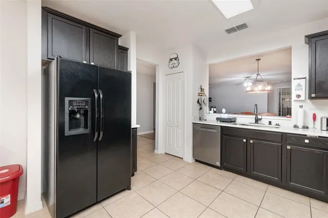 a kitchen with a refrigerator and a sink