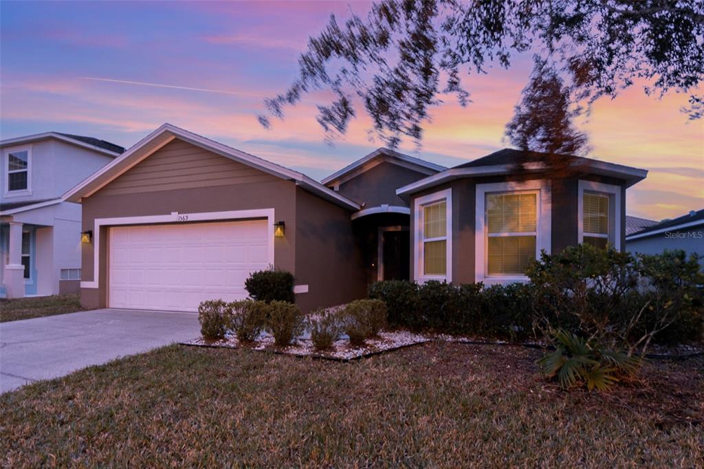 1569 Tamarind Road Davenport, FL 33896 - Photo 2 of 27 a front view of a house with garden