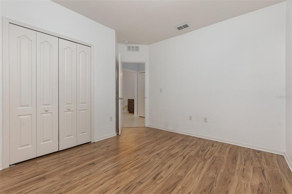 1569 Tamarind Road Davenport, FL 33896 - Photo 21 of 27 a view of an empty room with wooden floor