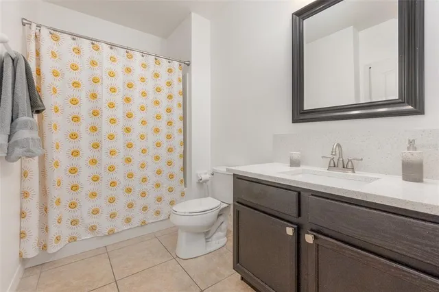 a bathroom with a sink toilet and a mirror