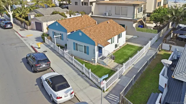 an aerial view of a house with swimming pool and furniture