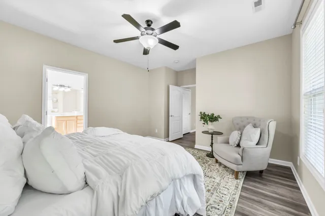 a spacious bedroom with a bed a couch and a window