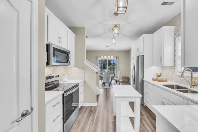 a kitchen with a sink stove and cabinets