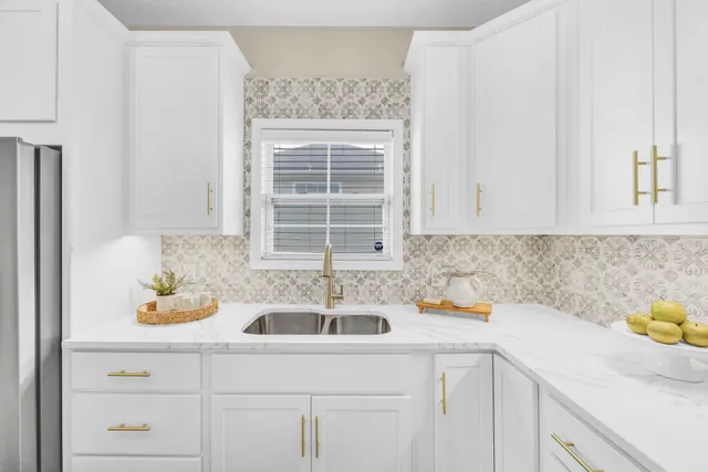a kitchen with a sink cabinets and window