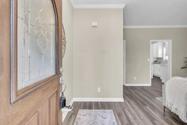 a view of a hallway with wooden floor and staircase