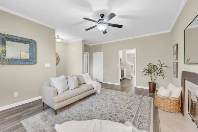 a living room with furniture and a chandelier