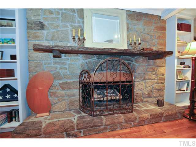 Perfect family room with large stone masonry fireplace, built-in shelves, and new hardwoods Den/Family/Great Room