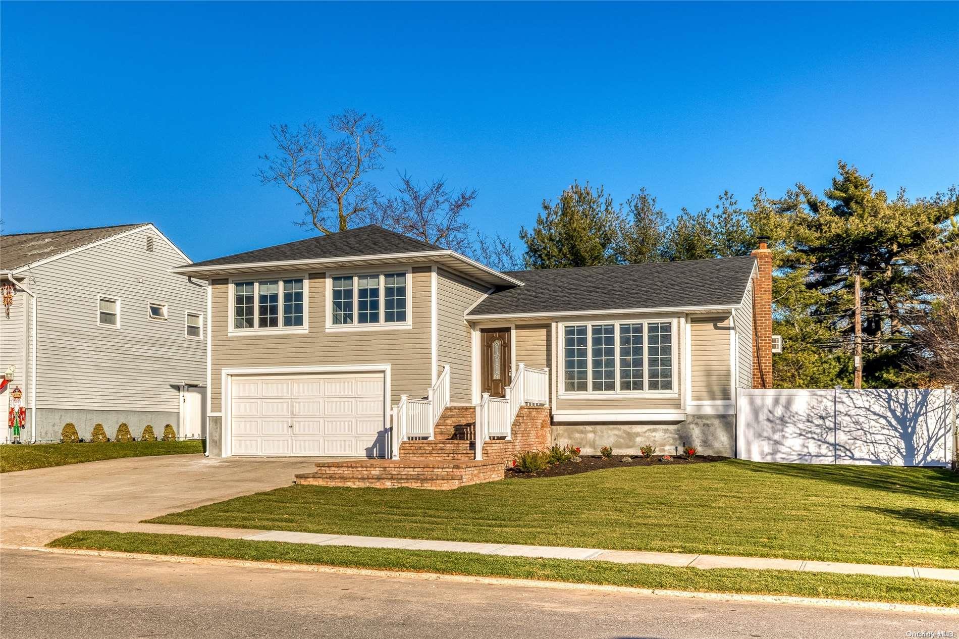 15 Florgate Road Farmingdale, NY 11735 - Photo 1 of 1 a front view of a house with a garden