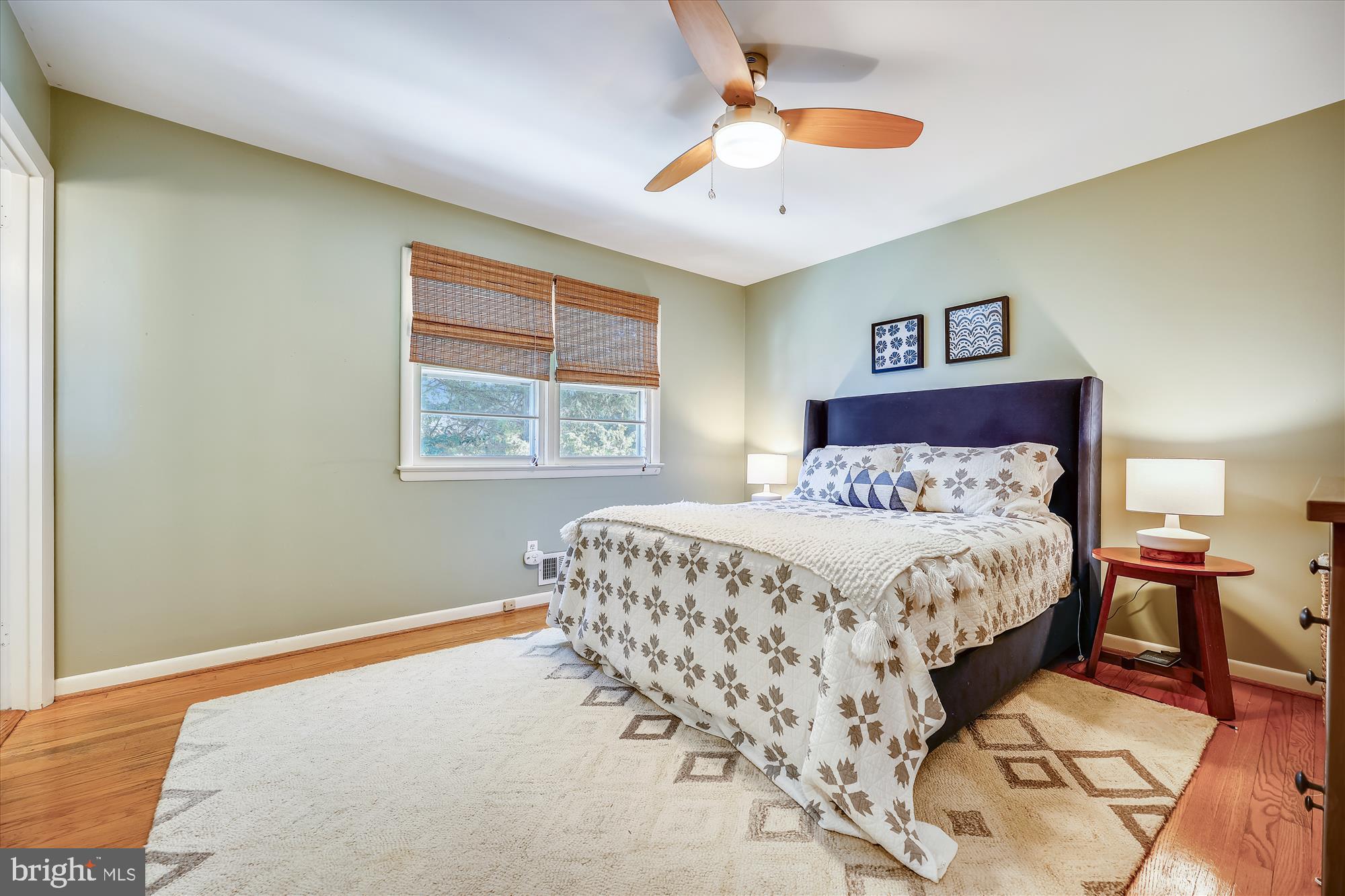 11310 Mapleview Drive Silver Spring, MD 20902 - Photo 14 of 40 a bedroom with a large bed and a chandelier