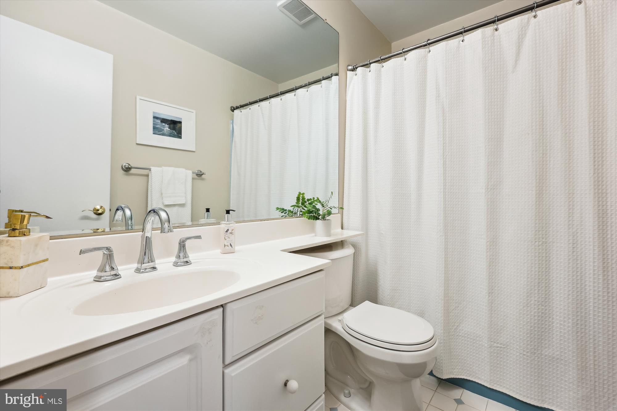 11310 Mapleview Drive Silver Spring, MD 20902 - Photo 18 of 40 a bathroom with a sink a toilet and a mirror