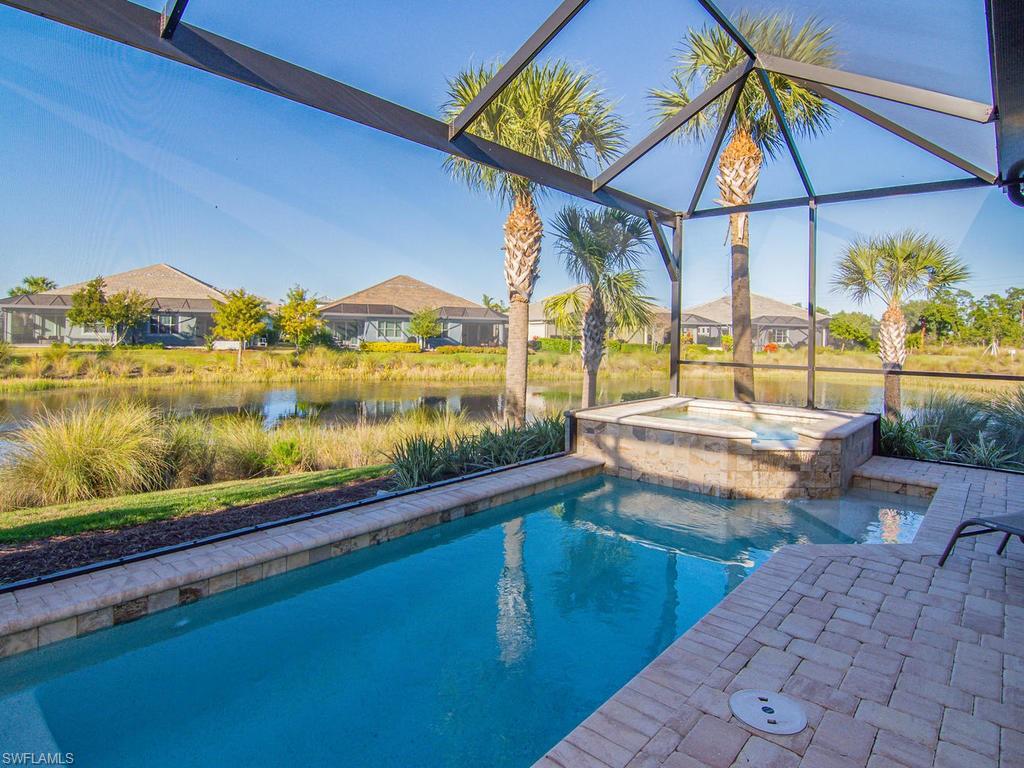 7002 Dominica Drive Naples, FL 34113 - Photo 14 of 33 a view of swimming pool with a patio and a yard