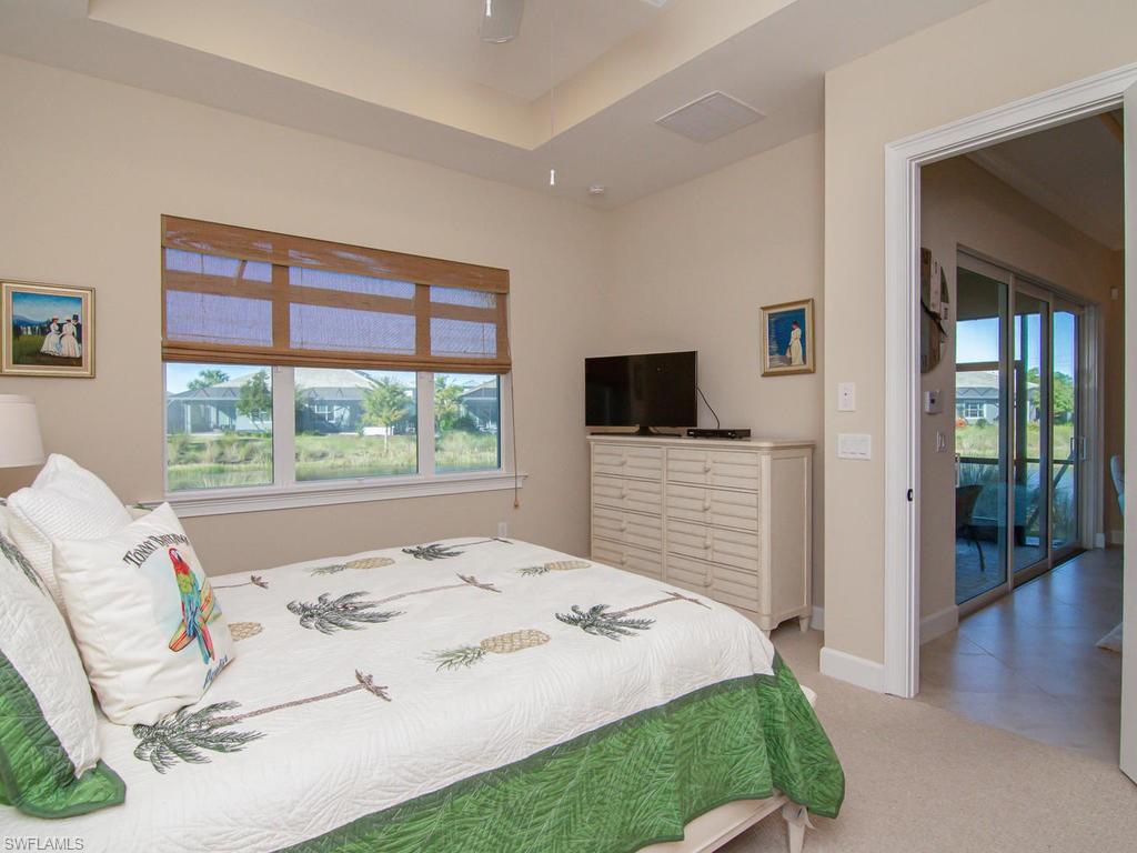 7002 Dominica Drive Naples, FL 34113 - Photo 17 of 33 a bedroom with a bed and a flat screen tv
