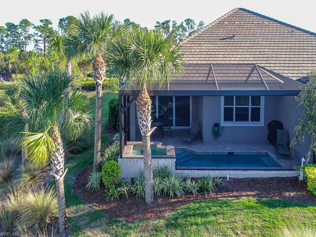 7002 Dominica Drive Naples, FL 34113 - Photo 19 of 33 a front view of a house with garden
