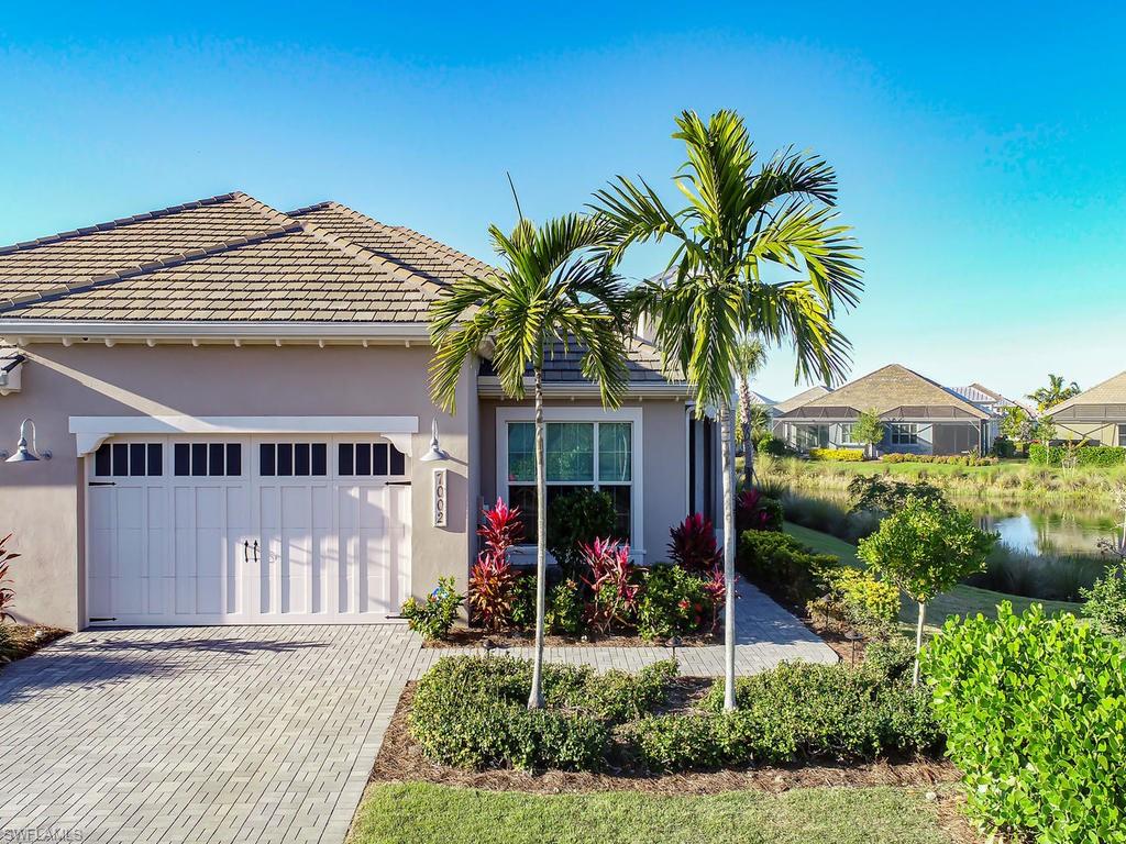 7002 Dominica Drive Naples, FL 34113 - Photo 20 of 33 a front view of a house with a yard