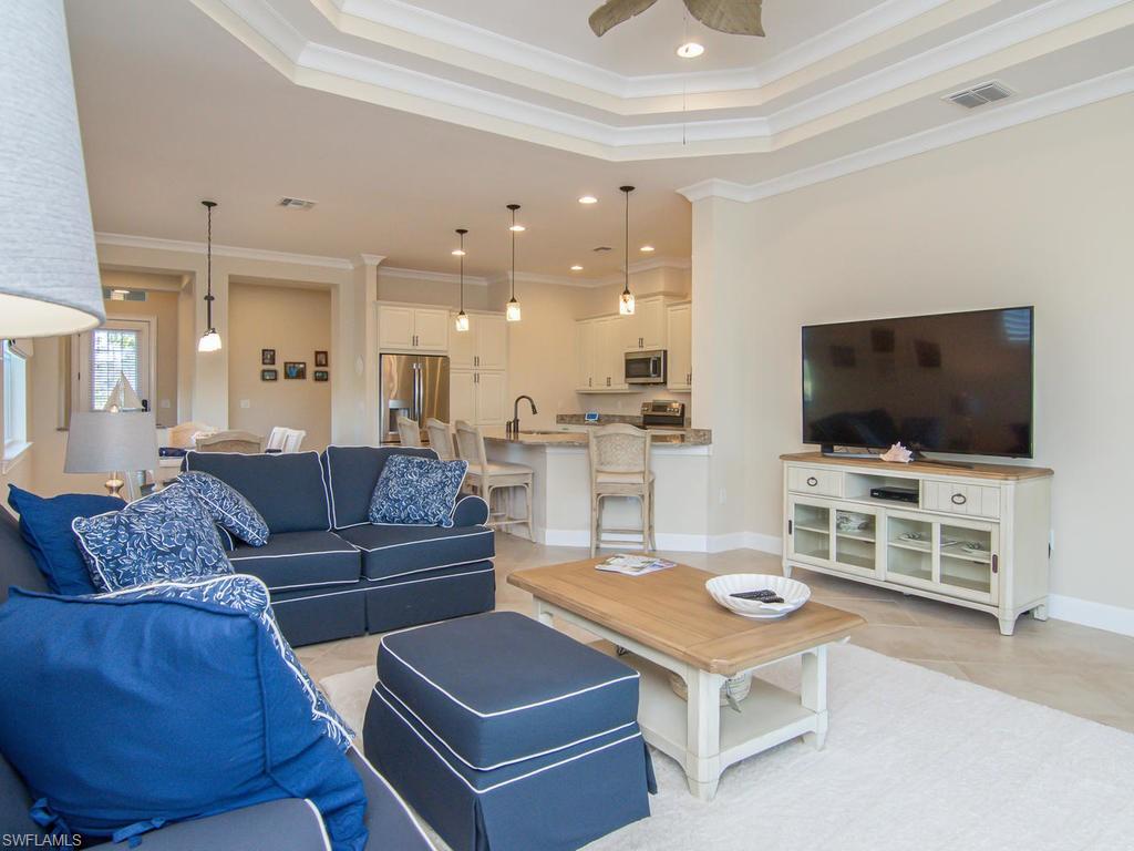 7002 Dominica Drive Naples, FL 34113 - Photo 2 of 33 a living room with furniture and a flat screen tv