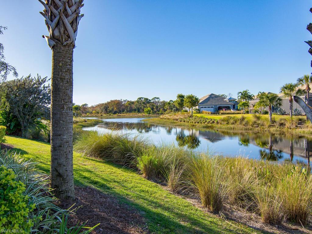 7002 Dominica Drive Naples, FL 34113 - Photo 21 of 33 a view of a lake with a big yard