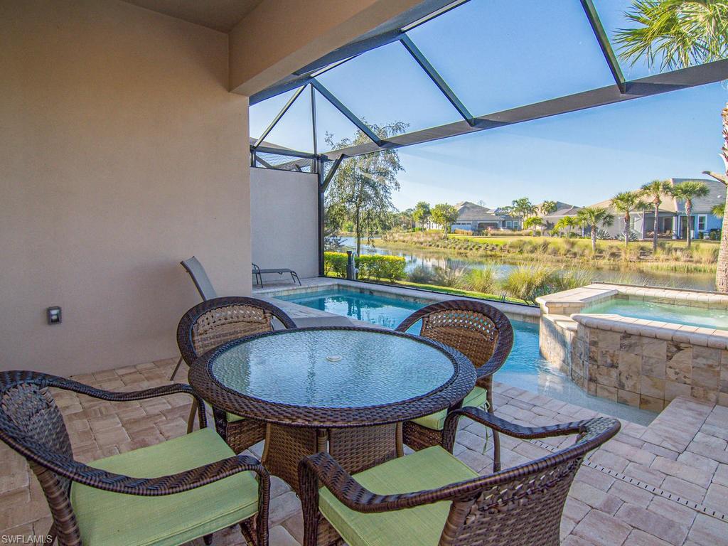 7002 Dominica Drive Naples, FL 34113 - Photo 22 of 33 a dining room with furniture and a floor to ceiling window