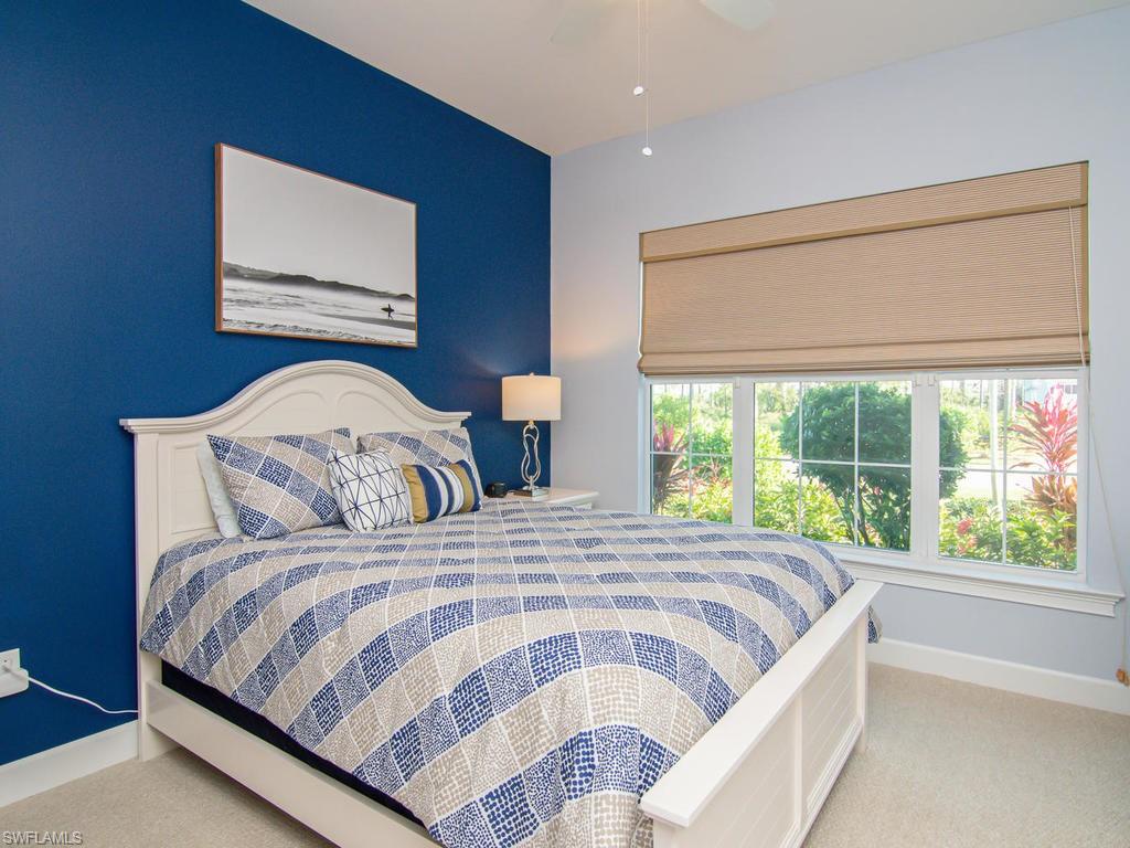 7002 Dominica Drive Naples, FL 34113 - Photo 23 of 33 a bedroom with a large bed and a large window