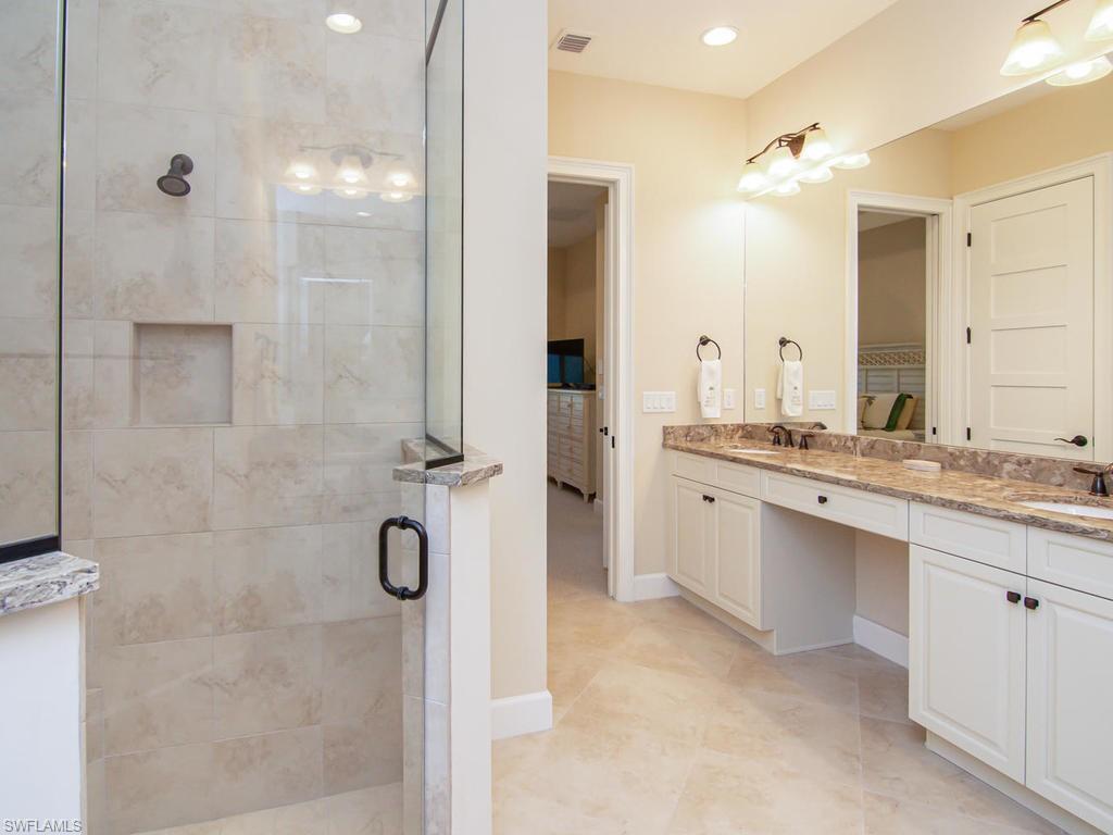 7002 Dominica Drive Naples, FL 34113 - Photo 25 of 33 a bathroom with a double vanity sink mirror and double