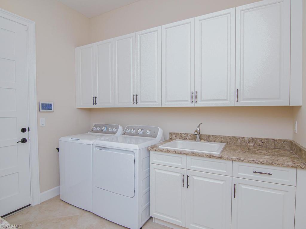 7002 Dominica Drive Naples, FL 34113 - Photo 27 of 33 a view of cabinets with white cabinets