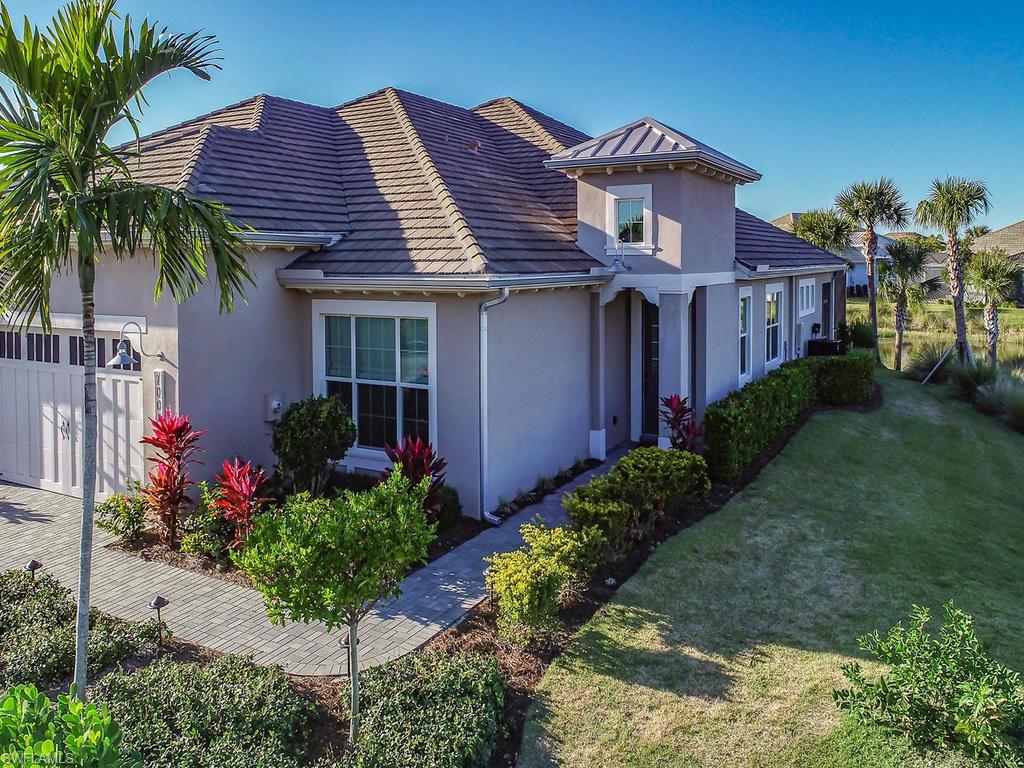 7002 Dominica Drive Naples, FL 34113 - Photo 28 of 33 a front view of a house with a yard