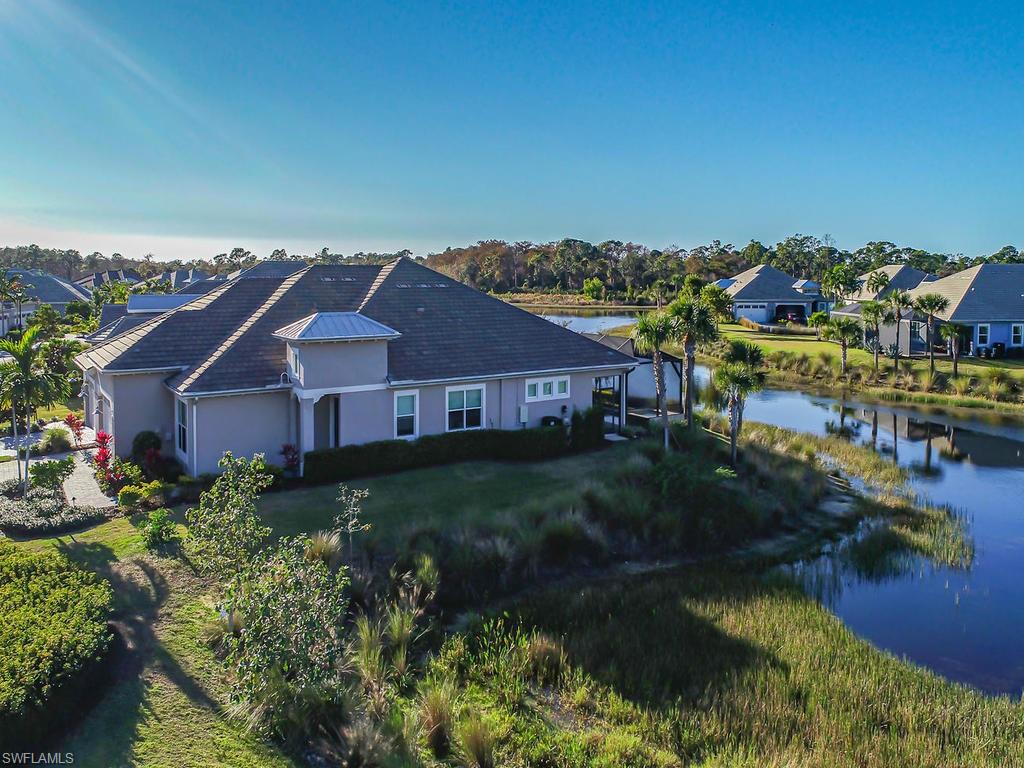 7002 Dominica Drive Naples, FL 34113 - Photo 29 of 33 a aerial view of a house with a garden and lake view