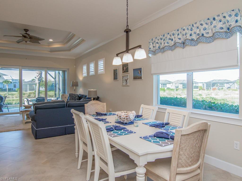7002 Dominica Drive Naples, FL 34113 - Photo 5 of 33 a dining room with furniture a chandelier and window