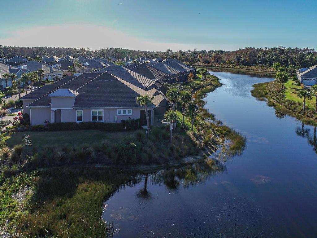 7002 Dominica Drive Naples, FL 34113 - Photo 6 of 33 a aerial view of a house with a lake view