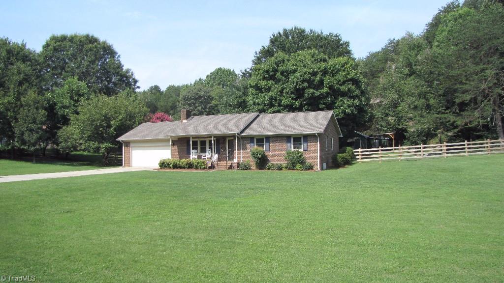 3963 Lewiston Road Summerfield, NC 27358 - Photo 3 of 22 Exterior front with fenced backyard