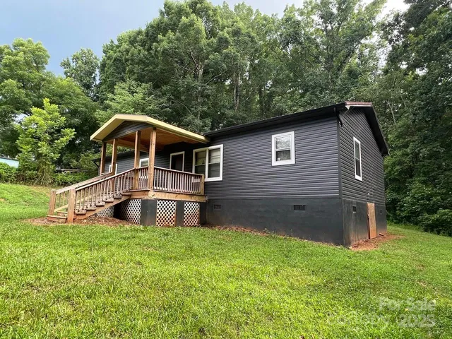 a front view of a house with yard and green space