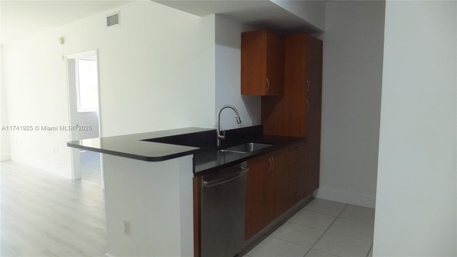2775 Northeast 187th Street, Unit 329 Aventura, FL 33180 - Photo 13 of 21 a kitchen with a sink and a mirror