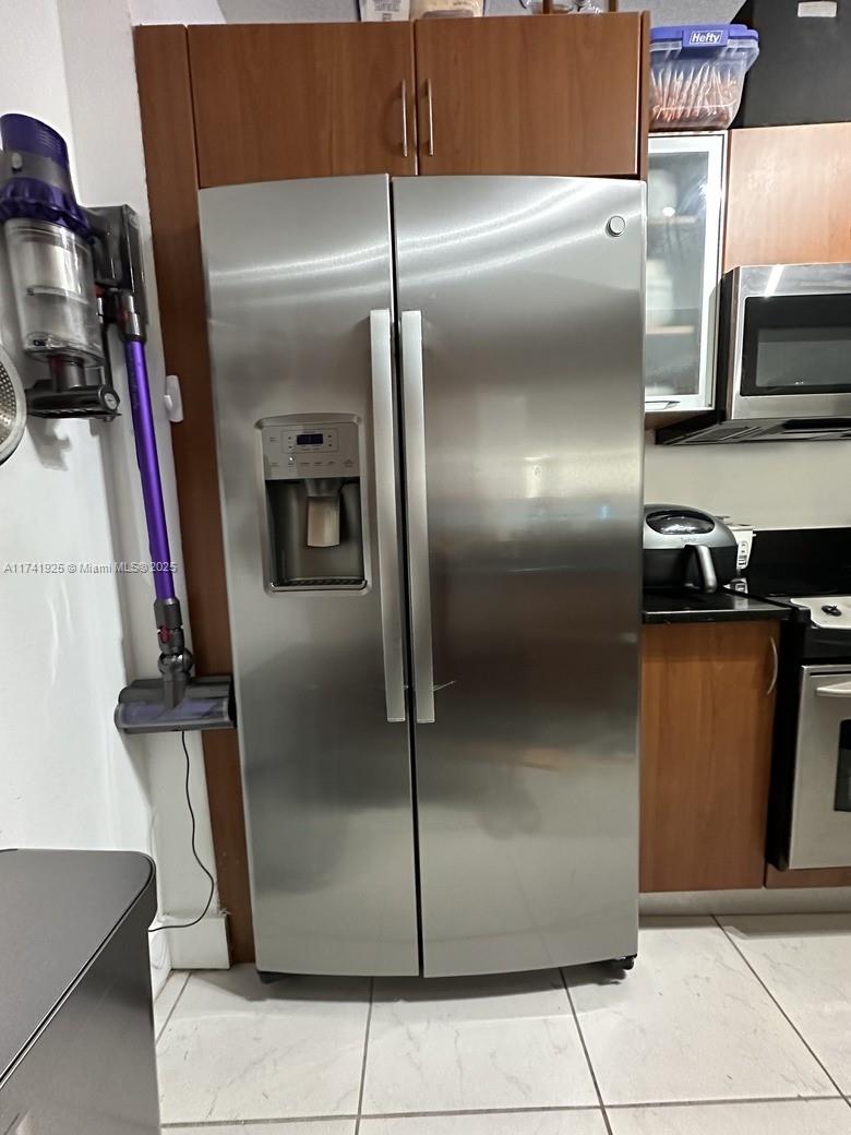 2775 Northeast 187th Street, Unit 329 Aventura, FL 33180 - Photo 15 of 21 a metallic refrigerator freezer sitting inside of a kitchen