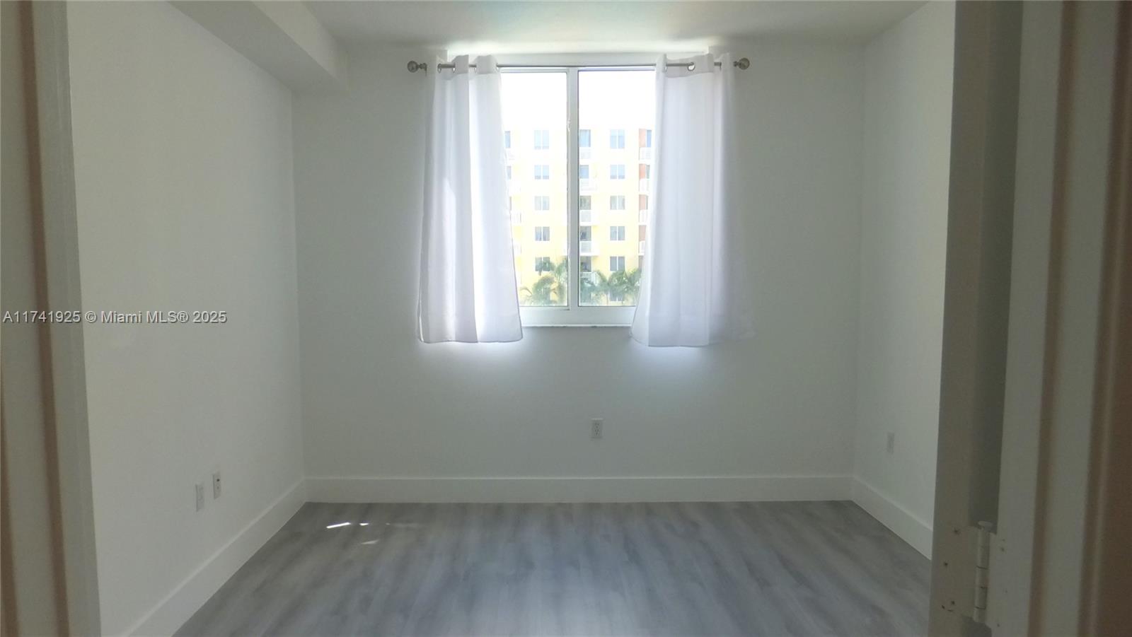 2775 Northeast 187th Street, Unit 329 Aventura, FL 33180 - Photo 4 of 21 an empty room with a window